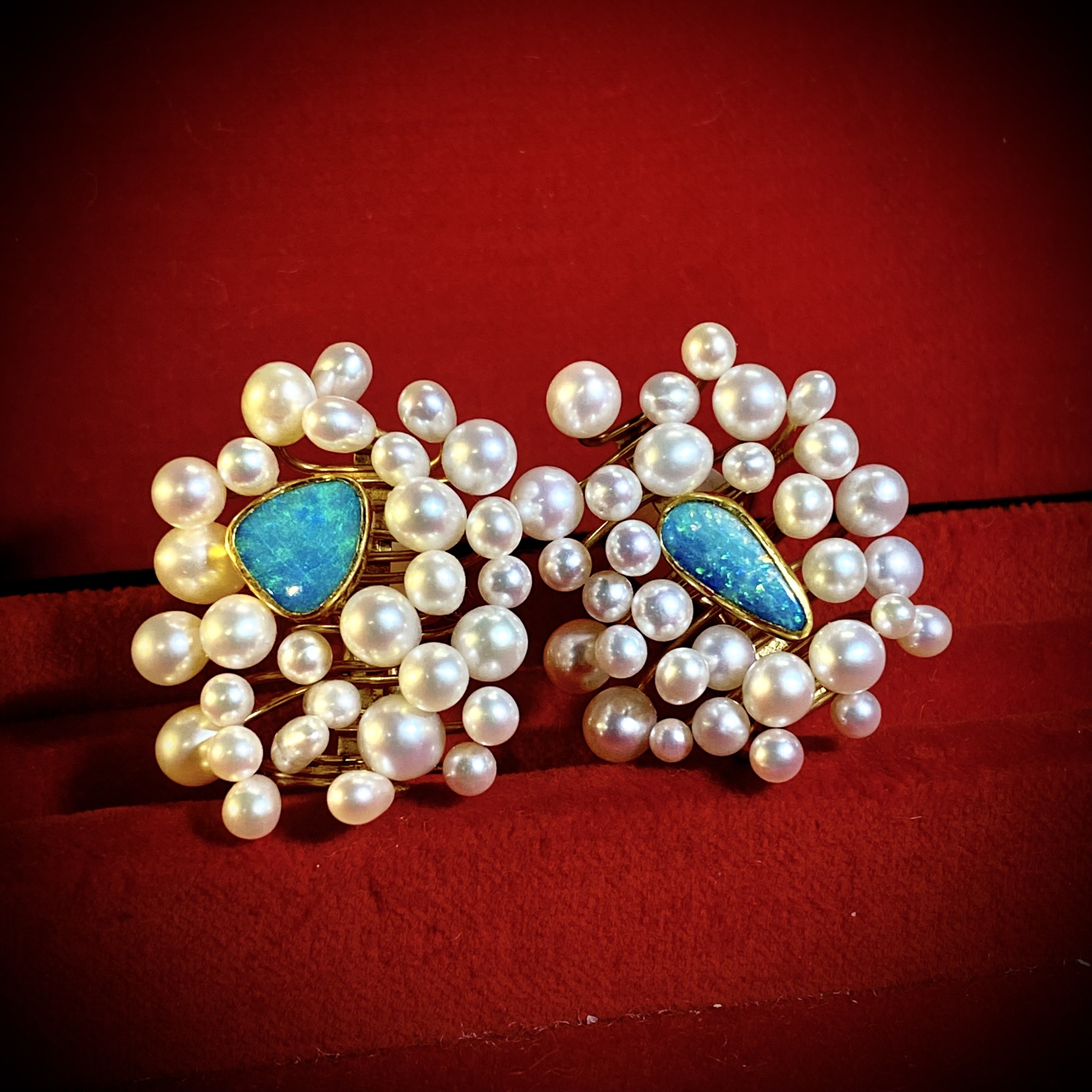 Black opal and pearl earrings signifying rare gemstones
